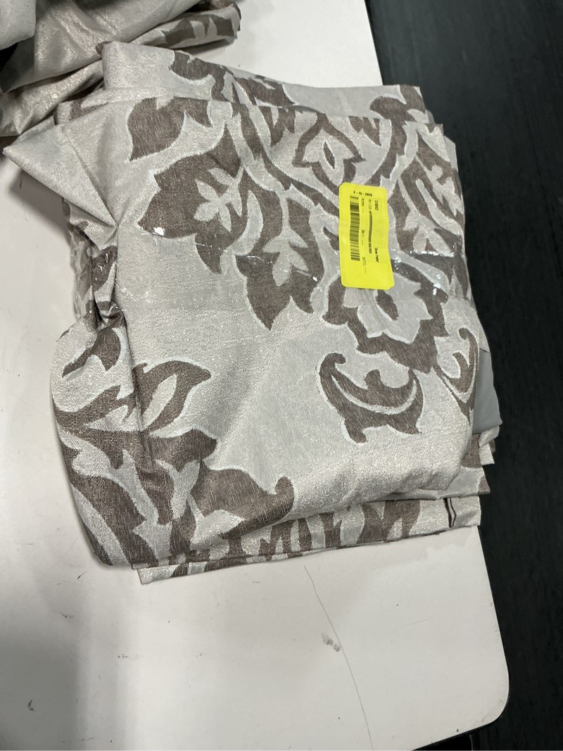 Condition photo showing As Is for sun zero 2-pack arlo textured thermal insulated grommet curtain panel pair  brown/damask 40  w x 84  l