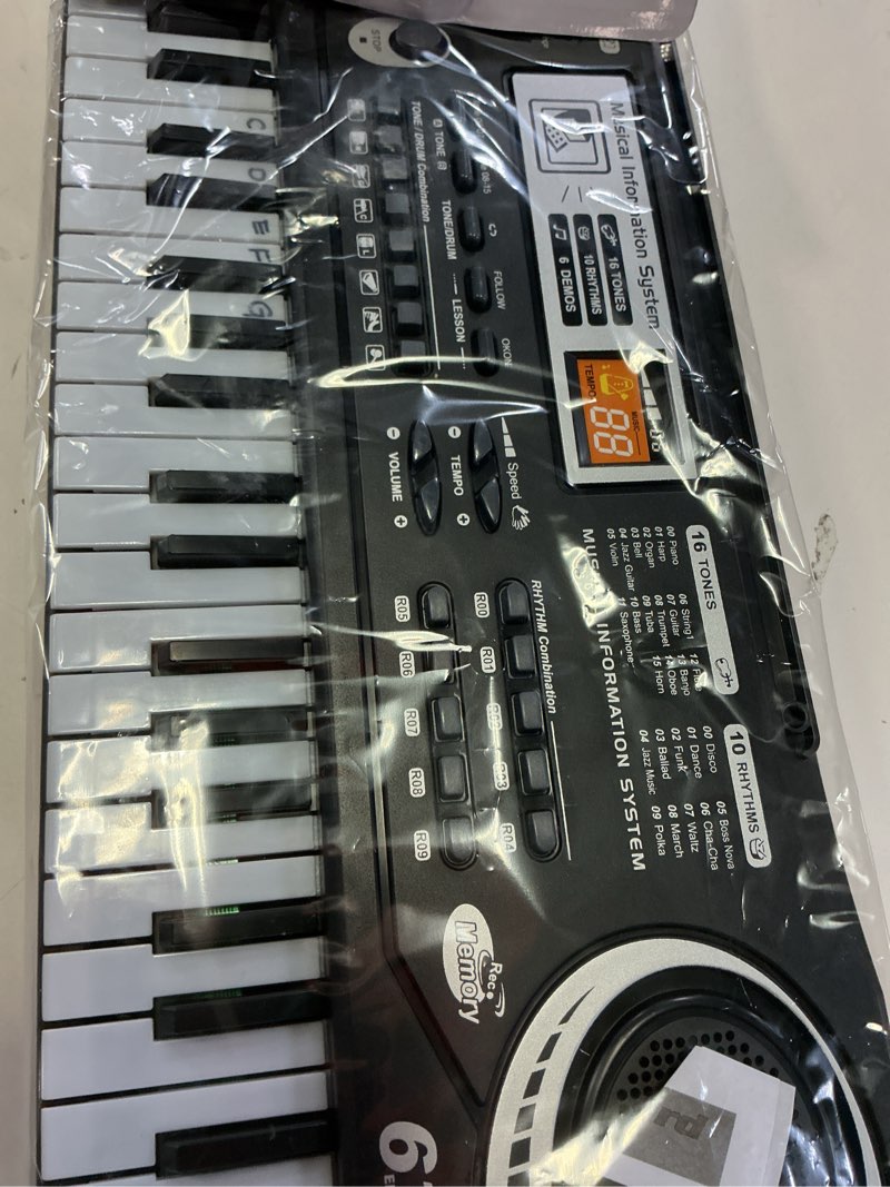 Condition photo showing Good Condition for 61 key piano keyboard for kids, electronic music toy for beginners, 16 tones, 10 rhythms, 6 demos, built-in recording, perfect christmas or birthday gift for ages 3+ black and white