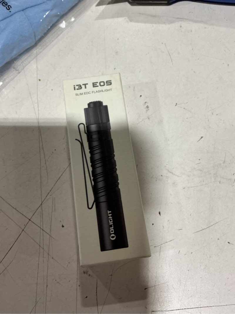 Condition photo showing New/Like New for olight i3t eos 180 lumens dual-output slim edc flashlight for camping and hiking, tail switch flash light with aaa battery (black)