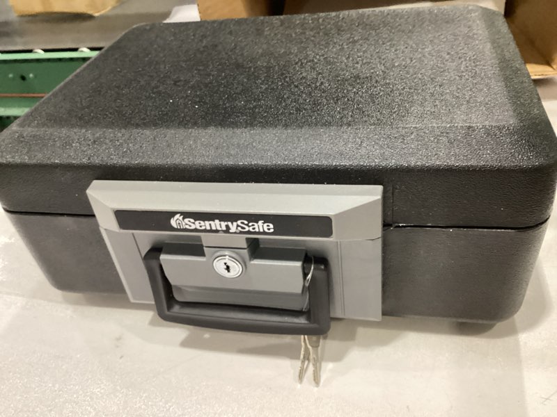 Condition photo showing New/Like New for SentrySafe Fireproof Safe Box with Key Lock, Chest Safe with Carrying Handle to Secure Money, Jewelry, Documents, 0.25 Cubic Feet, 6.3 x 15.3 x 12.1 Inches, 1160 Fire resistant box 0.25 cu. ft.