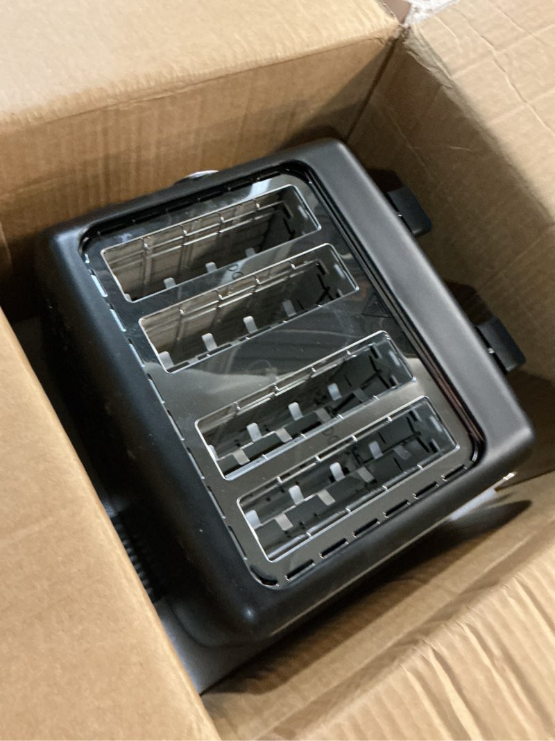 Condition photo showing As Is for amazon basics 4 slice toaster, 7 browning settings, extra wide slots for bagels and specialty breads, removable crumb tray, cancel/defrost/bagel buttons, 1500w, black & silver 4 slice matte black front
