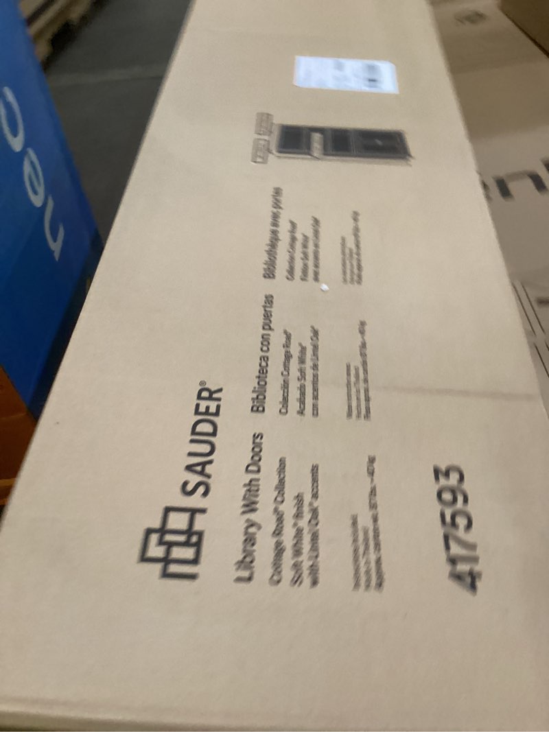 Condition photo showing As Is for Sauder Cottage Road Book Shelf, Bookshelf with Storage, Library Bookcase with Doors and Adjustable Shelves, in Soft White Finish