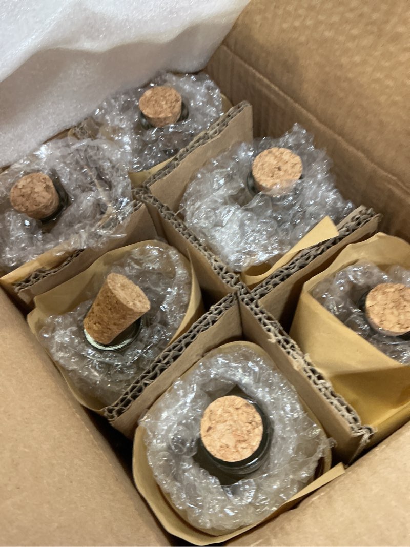Condition photo showing New/Like New for bulk paradise assorted clear glass bottles with corks, 6 pack, 2.5in x 9in, 16oz