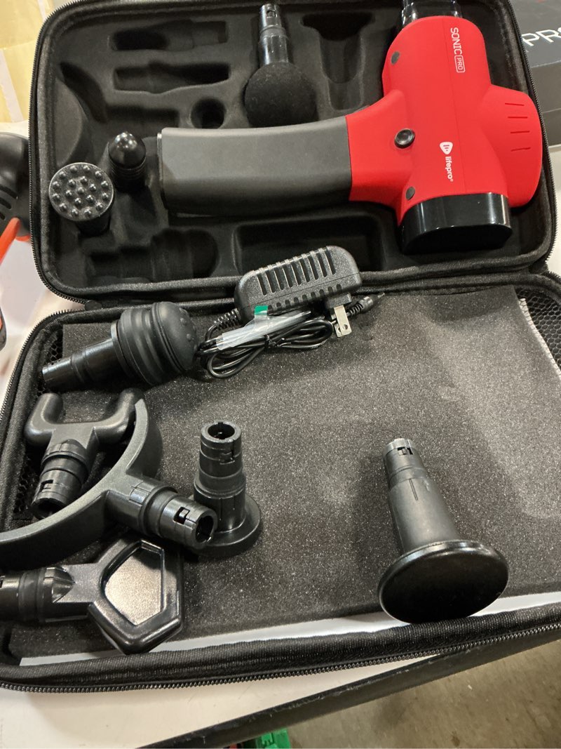 Condition photo showing As Is for lifepro sonic pro handheld electric massage gun – deep tissue percussion massager gun with 10 speeds & 9 heads – muscle massager for athletes back, legs, arms red