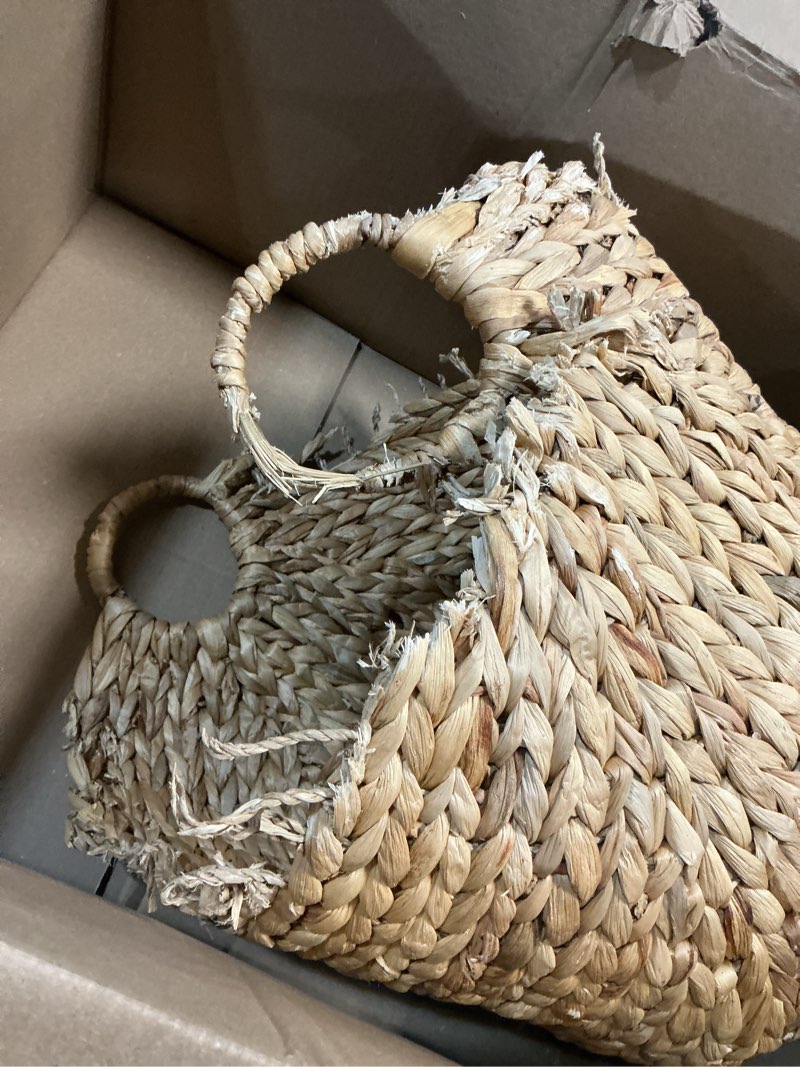 Condition photo showing As Is for Deco 79 Seagrass Handmade Decorative and Functional Storage Basket Large Woven Basket Organizer with Ring Handles, Basket for Storage 20" x 18" x 19", Brown 20" x 18" x 19" Brown