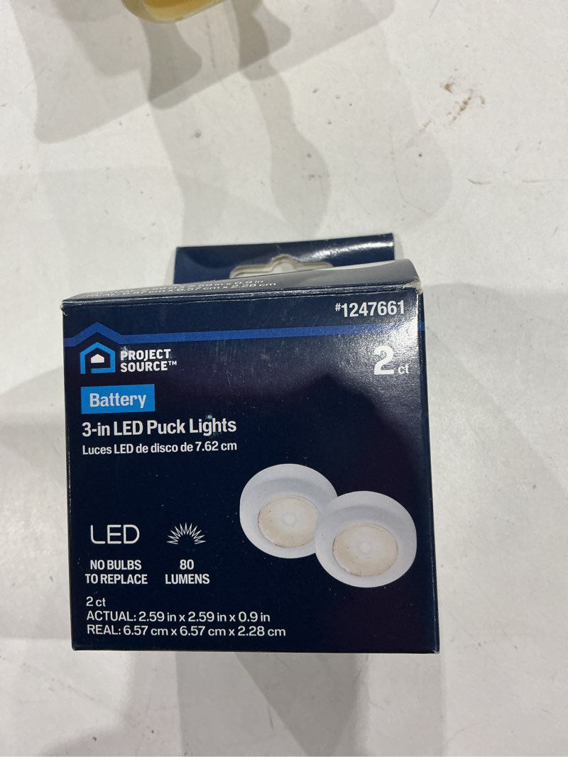 Condition photo showing As Is for project source led puck light 2 -pack 2.6-in battery led under cabinet puck light
