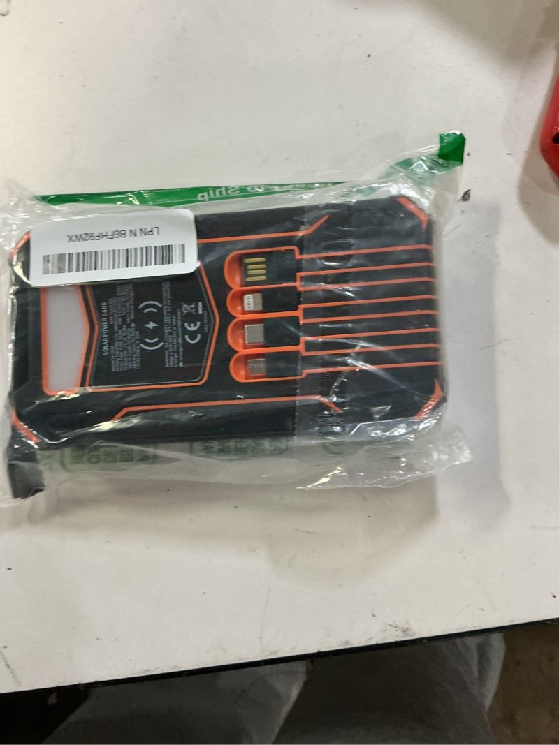 Condition photo showing As Is for soaraise solar charger power bank - 48000mah wireless portable charger built-in 4 cables and 4 solar panels, pd qc 3.0 fast charging usb c battery pack with flashlight for camping travel orange