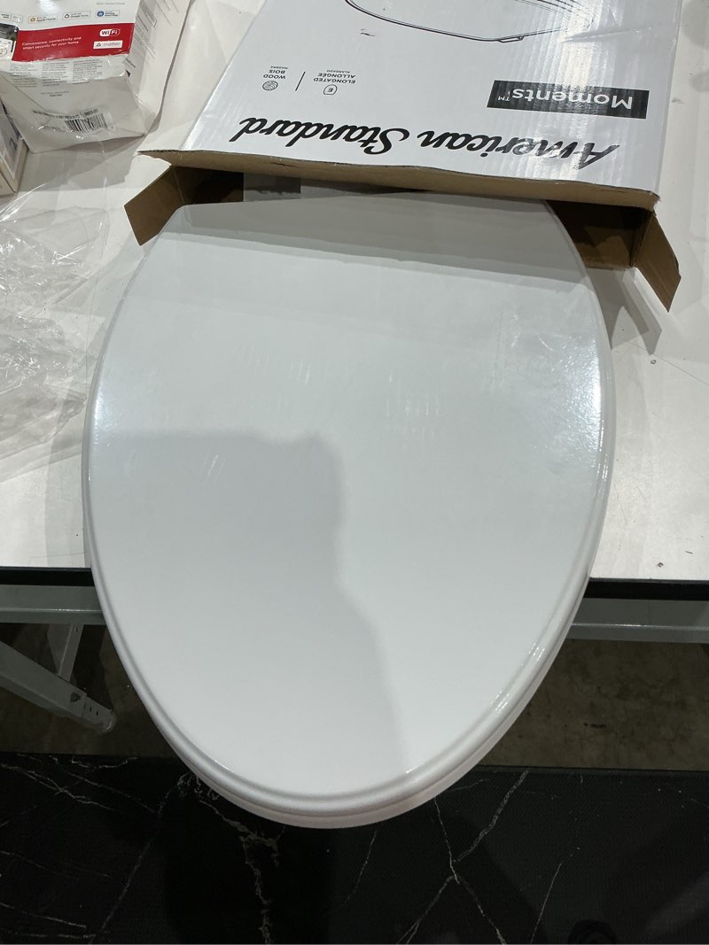 Condition photo showing As Is for american standard moments wood white elongated soft close toilet seat