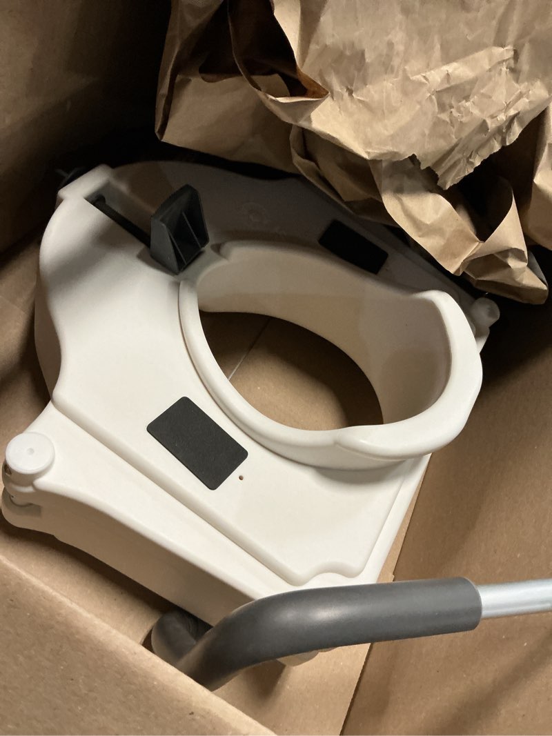 Condition photo showing As Is for bath safetyraised toilet seat product description: elev.toilet seat w/ remarms,rtl,1 ea