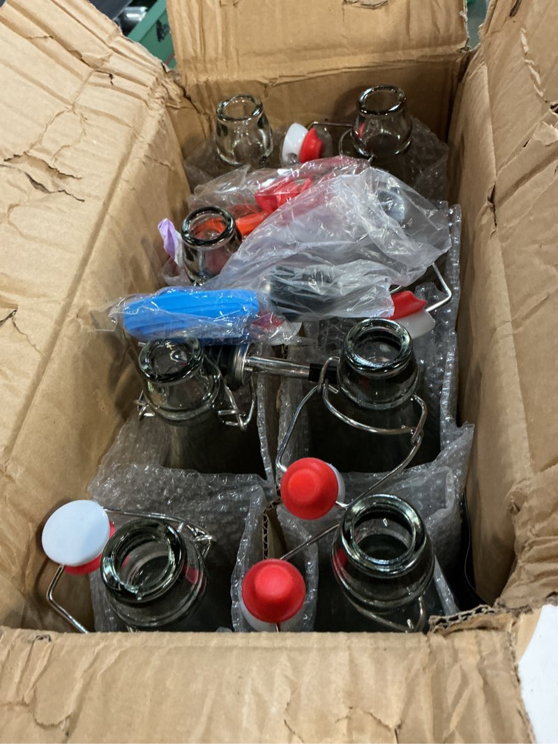 Condition photo showing New/Like New for 8 pack [1 l / 33 fl. oz.] swing top glass bottles w/ airtight stopper lids – flip top brewing bottle for fermentation, kombucha, mead, vinegar, beer, kefir, wine, soda – with 8 extra seals & 2 pourer