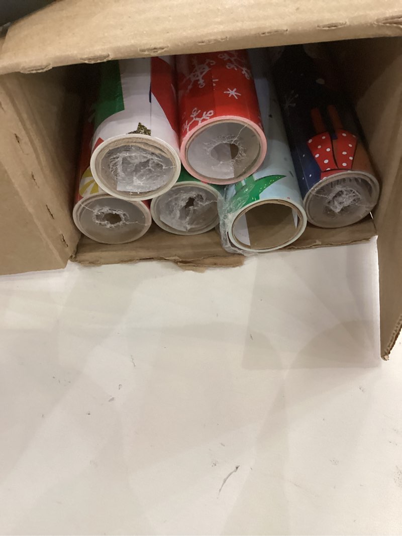 Condition photo showing As Is for Hallmark Kids Christmas Wrapping Paper Rolls with Cutlines on Reverse (6 Rolls: 180 Sq. Ft. Total) Dinosaur, Unicorn, Flamingo, Koala Snowman, Falala, Plaid, Snowflakes, Peppermints
