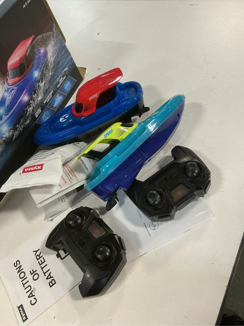 Condition photo showing As Is for syma 2 pack rc boats for kids, remote control boats for pool, 7-mode led light up & water spray, up to 40 min total (2 batteries), 2.4ghz 164 ft range, gift for boys & girls 7-mode led (upgraded)