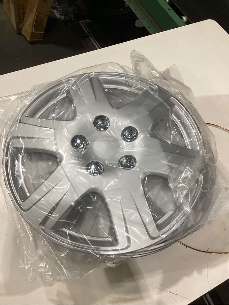 Condition photo showing New/Like New for four abs plastic silver colored hubcaps - 15 inch diameter