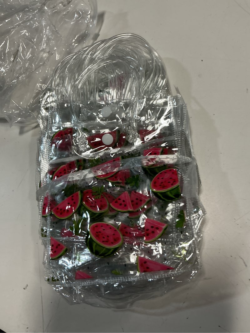 Condition photo showing Good Condition for Kolldenn 24 Pcs Watermelon Party Treat Bags Plastic Clear Watermelon Gift Bags with Handles PVC Goodie Shopping Handbags for Summer Kid Birthday Baby Shower Wedding Party Decor, 5.9 x 6.3 x 2.7 Inches