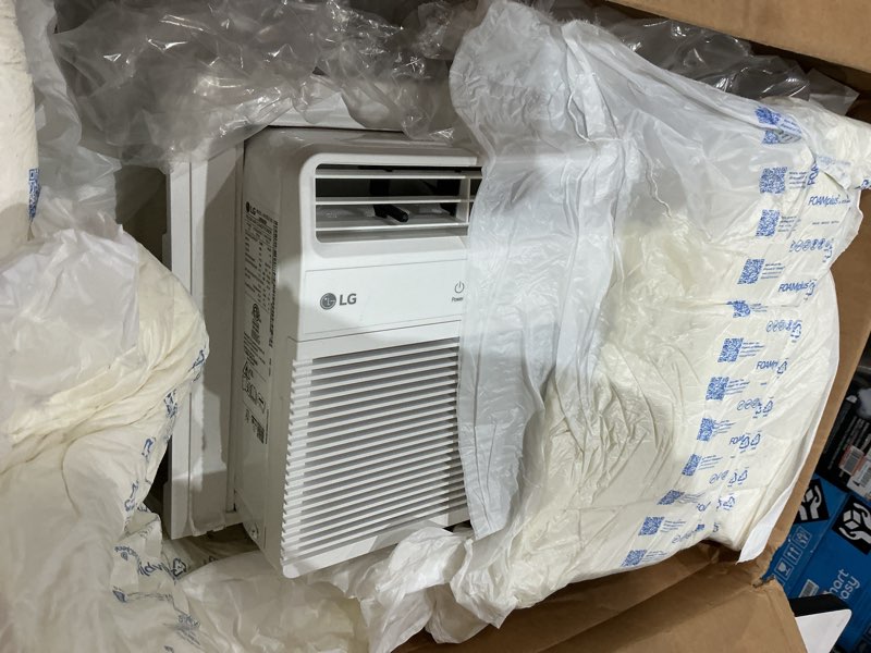 Condition photo showing As Is for lg 5000 btu window air conditioner with remote, easy button control ultra-quiet compact-size cools 150 sq.ft. for small room, washable filter ac unit easy installation white lw5025r