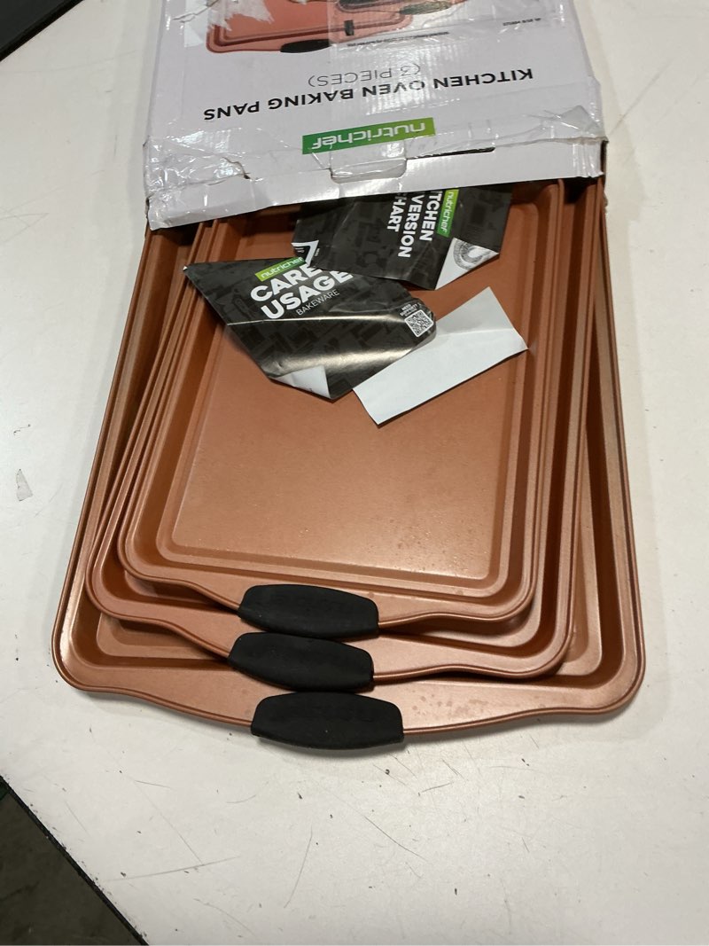 Condition photo showing Good Condition for NutriChef 3 Piece Cookie Sheets for Baking - PFOA, PFOS, PTFE Free Nonstick Carbon Steel Bakeware Set - Home Kitchen Bake Pan Cookie Sheet Stackable Baking Sheet w/Black Silicone Handles NCSBS3S45 3 Piece Set
