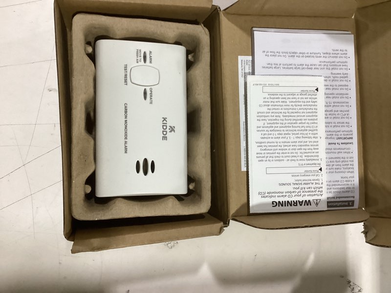 Condition photo showing As Is for kidde carbon monoxide detector, battery powered co alarm with leds, test-reset button, low battery indicator, portable frustration free packaging