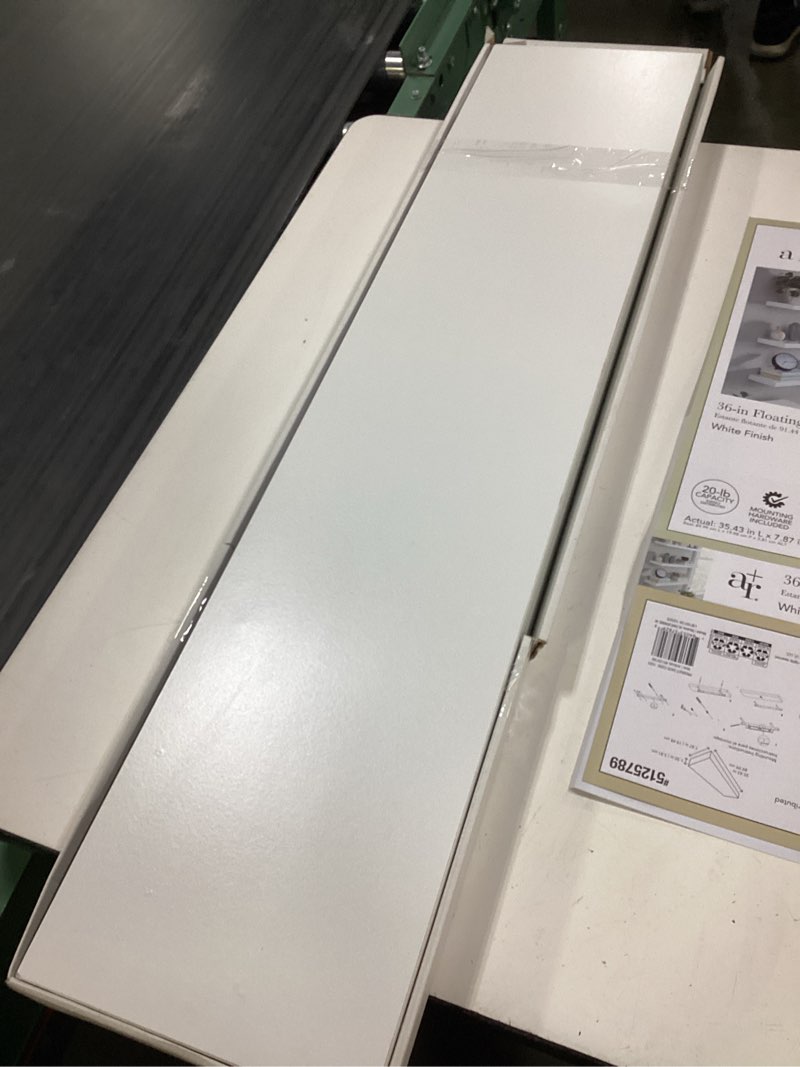 Condition photo showing As Is for allen + roth 8-in d x 36-in l white composite wood rectangular floating shelf