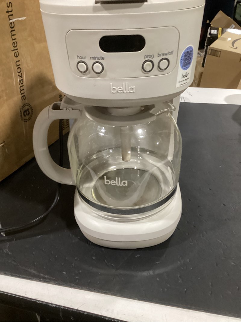 Condition photo showing As Is for bella 12 cup programmable coffee marker, reusable dishwasher safe accessories, easy lcd diaply, auto shutoff, 900 watt, oatmilk