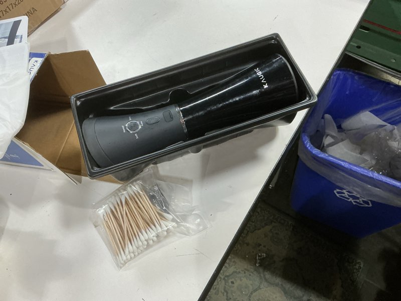 Condition photo showing As Is for upgraded ear wax removal with one-piece waste tank, safe cleaner with water temperature sensor, effective ear irrigation kit & usb-a to c cable, ipx7, black