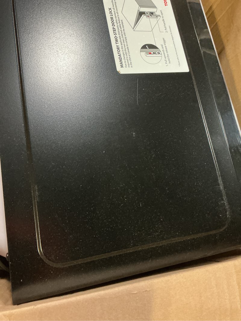 Condition photo showing As Is for toshiba ml-em09pa(bs) small microwave oven with 6 auto menus, mute function & child lock, led lighting, 0.9 cu ft, 10.6 inch removable turntable, 900w, countertop, black stainless steel advanced-0.9 cu ft-900w-black stainless steel