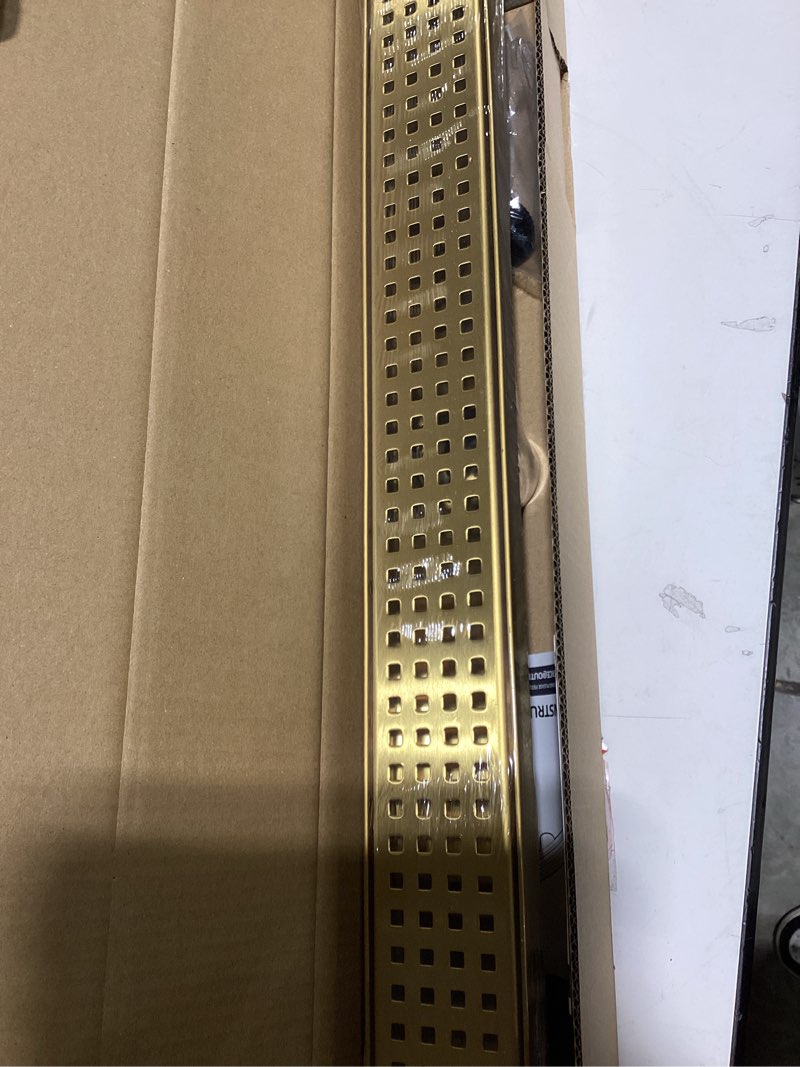Condition photo showing New/Like New for linear shower drain, 24 inch gold shower drain with removable square hole cover grate, bathroom modern 304 stainless steel brushed gold shower floor drain with adjustable feet,hair catcher brushed gold 24in