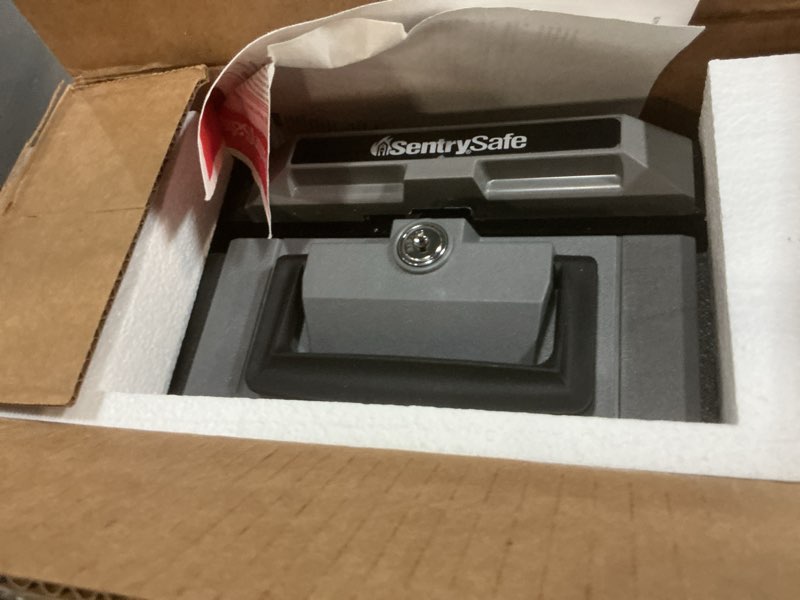 Condition photo showing New/Like New for sentrysafe fireproof safe box with key lock, chest safe with carrying handle to secure money, jewelry, documents, 0.25 cubic feet, 6.3 x 15.3 x 12.1 inches, 1160 fire resistant box 0.25 cu. ft.