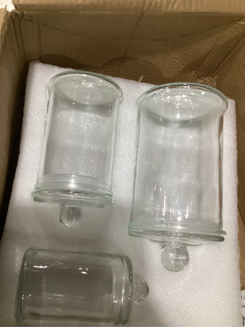 Condition photo showing Good Condition for as is cracked set of 3 glass apothecary jars with lids, bathroom canisters storage container jars, decorative small glass apothecary jar for cotton swabs, cotton balls, makeup sponges, bath salts