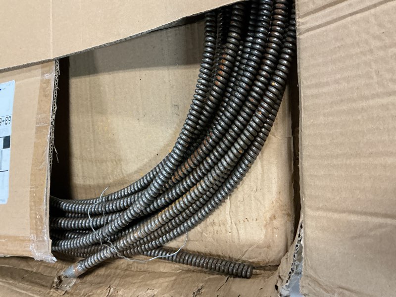 Condition photo showing As Is for dcd 31075slt drain cleaning cable, 3/8" x 75' with inner core and slotted cable couplings.