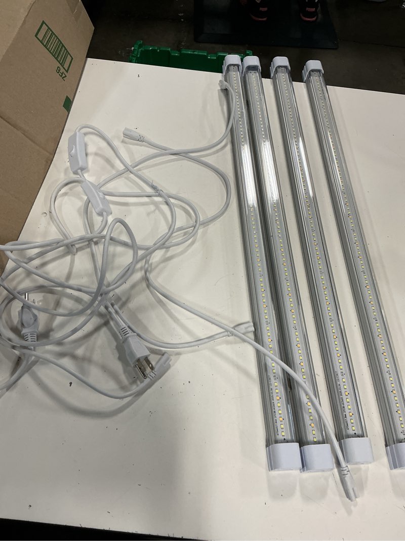 Condition photo showing Good Condition for four integrated 28” led tube fixtures with white power cords featuring inline on/off switches and plug connectors