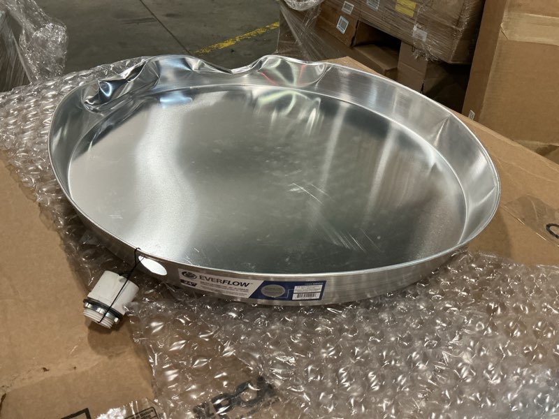 Condition photo showing As Is for everflow awhp24 aluminum water heater drain pan with 1 in. - 1-1/2 in. pvc fitting, 24 in. diameter chrome
