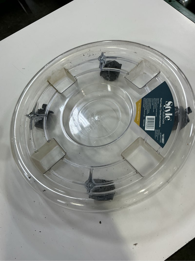 Condition photo showing As Is for style selections 16-in l x 16-in d x 3.34-in h clear plant caddy