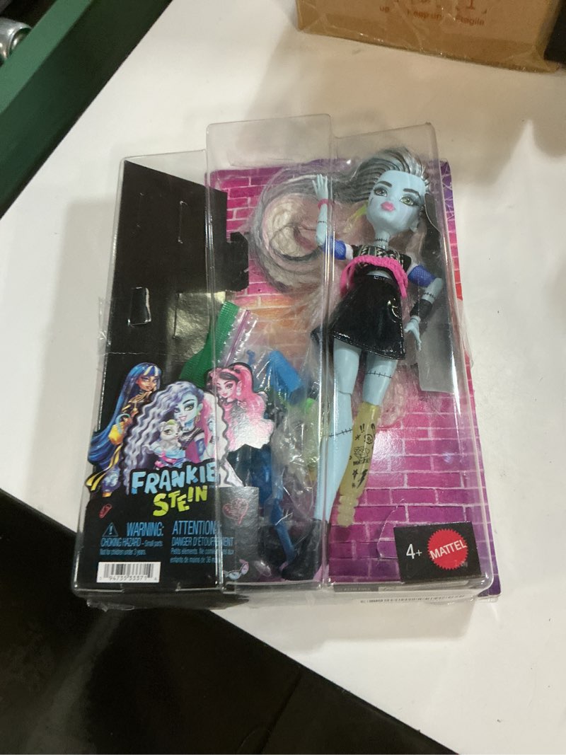 Condition photo showing As Is for monster high doll, frankie stein in cropped sweater and black pleather skirt with pet dog watzie and 7 accessories like earphones, belt bag and snacks