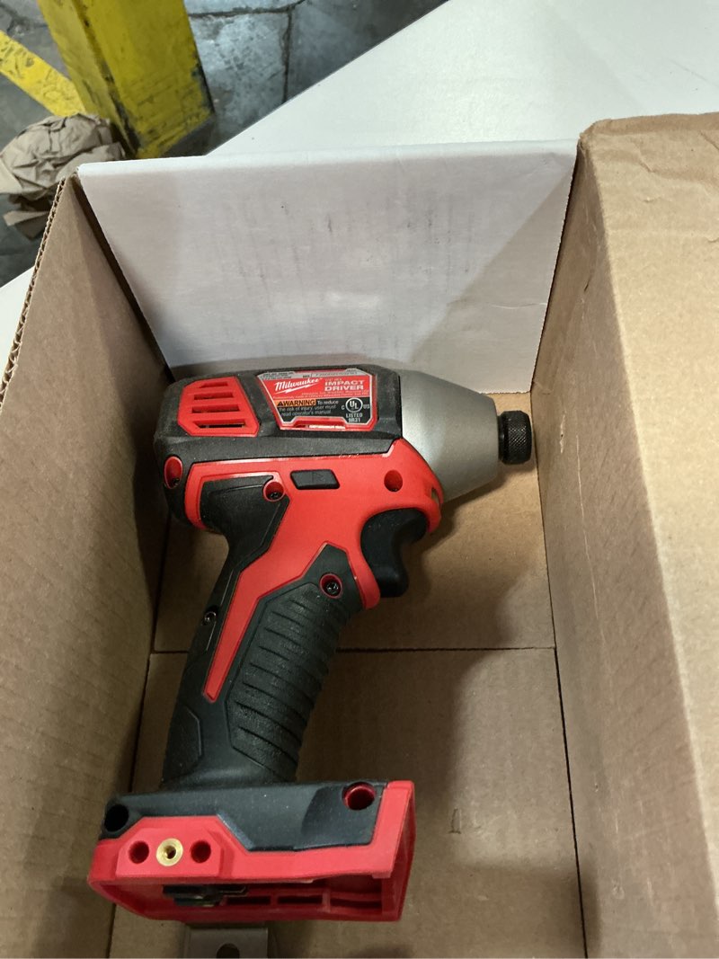 Condition photo showing As Is for milwaukee 2656-20 m18 18v 1/4 inch lithium ion hex impact driver with 1,500 inch pounds of torque and led lighting array (battery not included, power tool only)