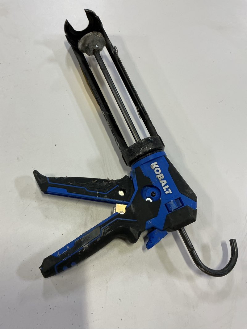 Condition photo showing As Is for kobalt dual thrust 10 -oz anti-drip smooth rod caulk gun
