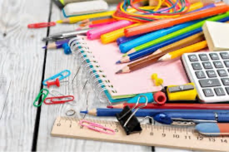 Mixture of office and school supplies ,paper ,pencils,notebooks,etc.