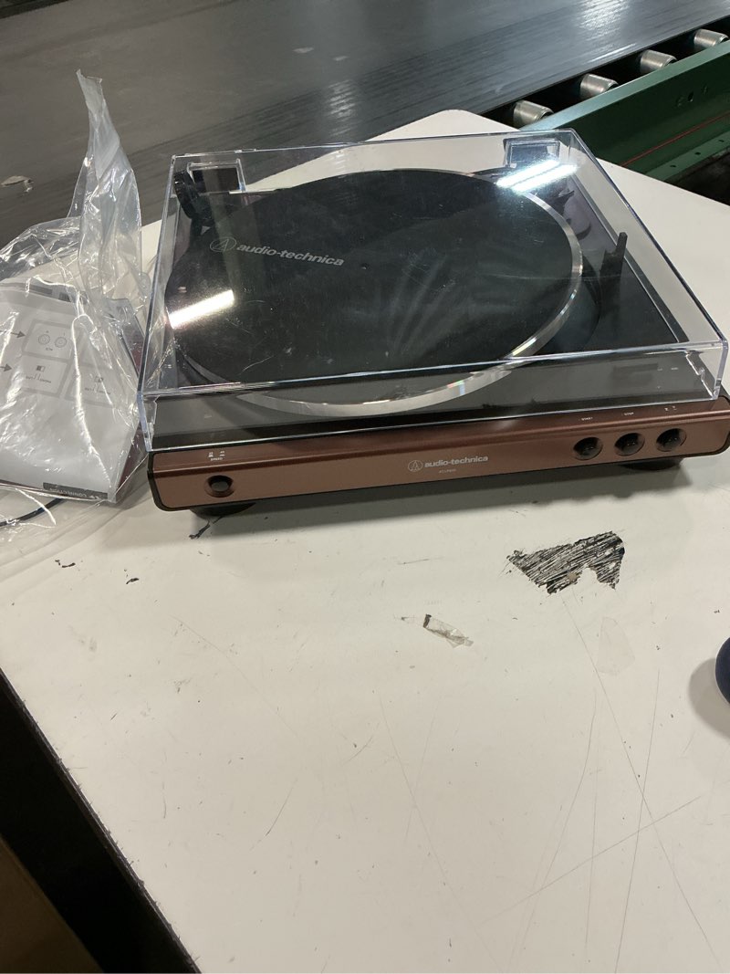 Condition photo showing As Is for audio-technica at-lp60x-bw fully automatic belt-drive stereo turntable, hi-fi, 2 speed, dust cover, anti-resonance, die-cast aluminum platter brown brown/black wired turntable