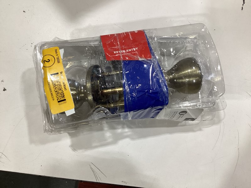 Condition photo showing As Is for tylo antique brass exterior entry door knob featuring microban antimicrobial technology