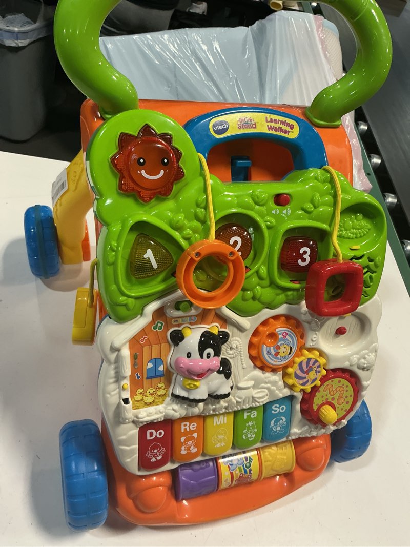 Condition photo showing As Is for vtech sit-to-stand learning walker (frustration free packaging) orange walker