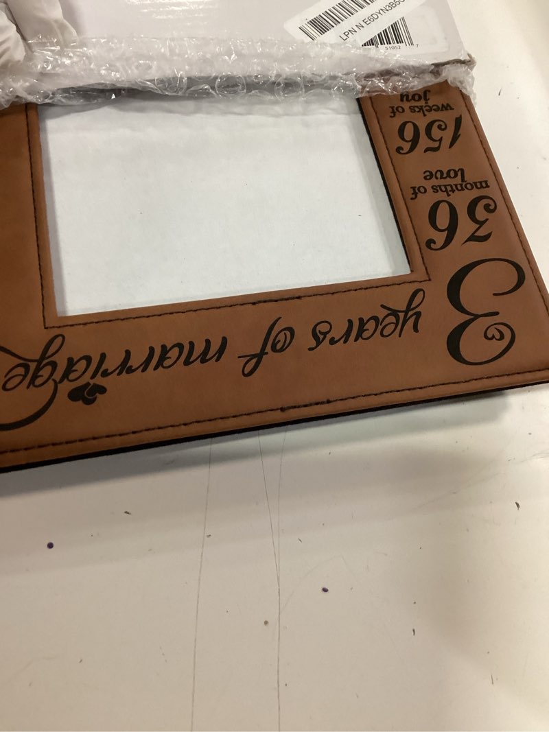 Condition photo showing New/Like New for bella busta- 3 years of marriage-3 years down forever to go-engraved leather picture frame (5 x 7 vertical (rawhide))