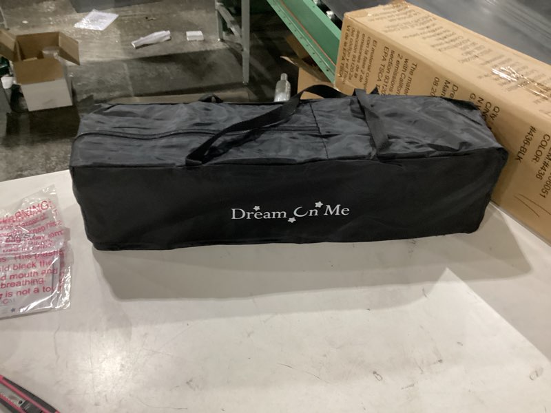 Condition photo showing New/Like New for dream on me nest portable playard in black with carrybag an shoulder strap, lightweight, packable and easy setup baby playard, breathable mesh sides and soft fabric - comes with a removable padded mat