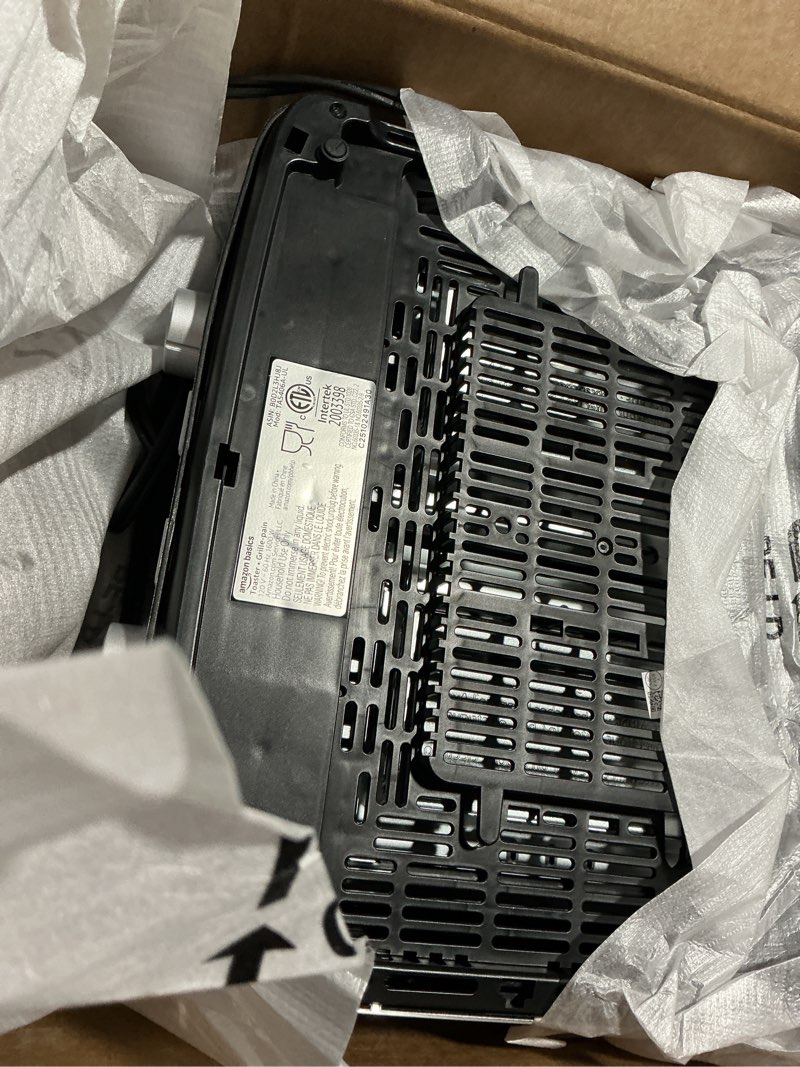 Condition photo showing As Is for Amazon Basics 4 Slice Toaster, With 7 Browning Settings, Extra Wide Slots For Bagels and Special Breads, Removable Easy-to-Clean Crumb Trays, Cancel/Defrost/Bagel Buttons, 1500W, Black & Silver 4 Slice Matte Black Front