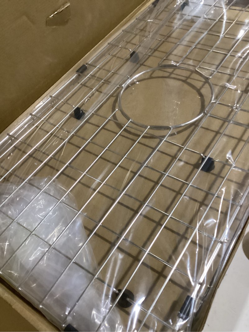 Condition photo showing Good Condition for serene valley sink bottom grid 24-1/8" x 12-5/8", centered drain with corner radius 1-1/2", sink protector nlw2412c