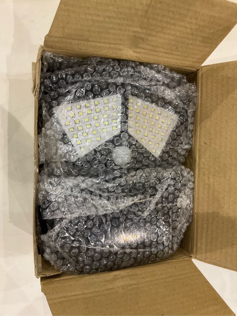Condition photo showing New/Like New for Solar Lights Outdoor [100 LED/3 Working Mode], Solar Security Lights Motion Sensor Lights Wireless IP65 Waterproof Solar Powered for Garden Fence Patio Garage Deck