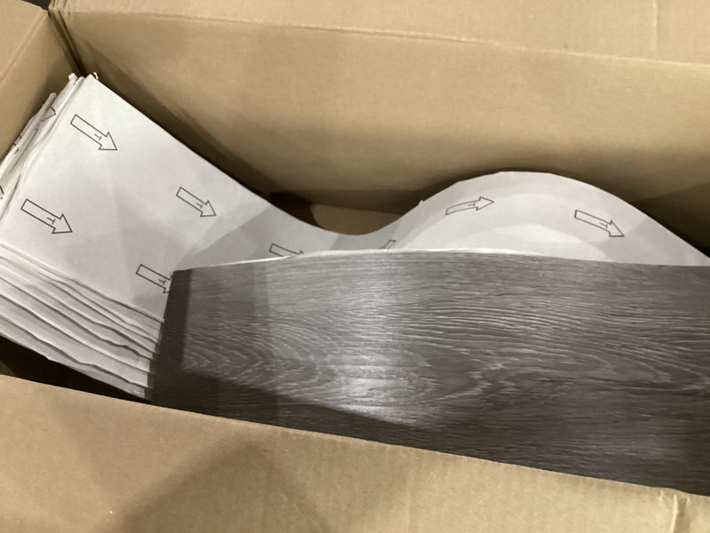 Condition photo showing New/Like New for gray wood vinyl peel and stick