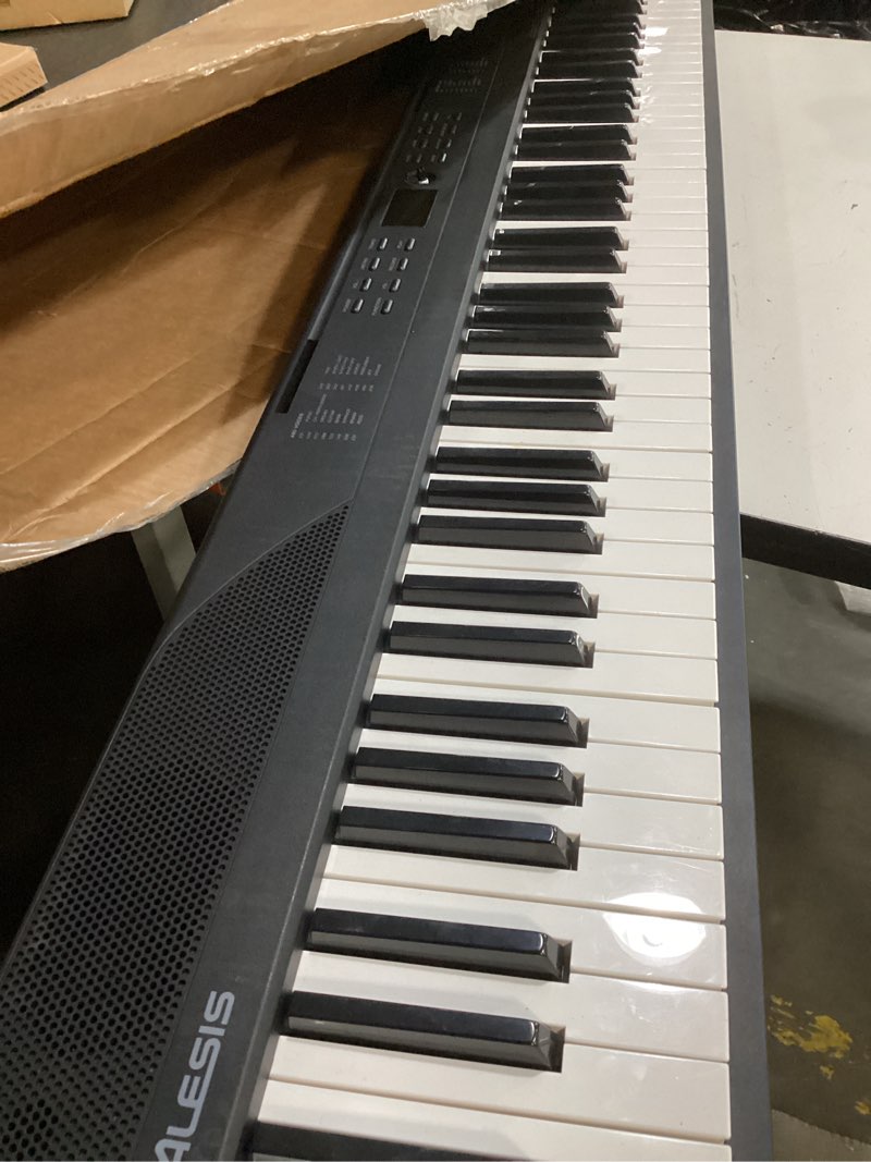 Condition photo showing Good Condition for alesis 88 key keyboard piano with 480 sounds, speakers, usb midi, sheet music tablet rest, power adapter and piano lessons for beginners recital play keyboard only