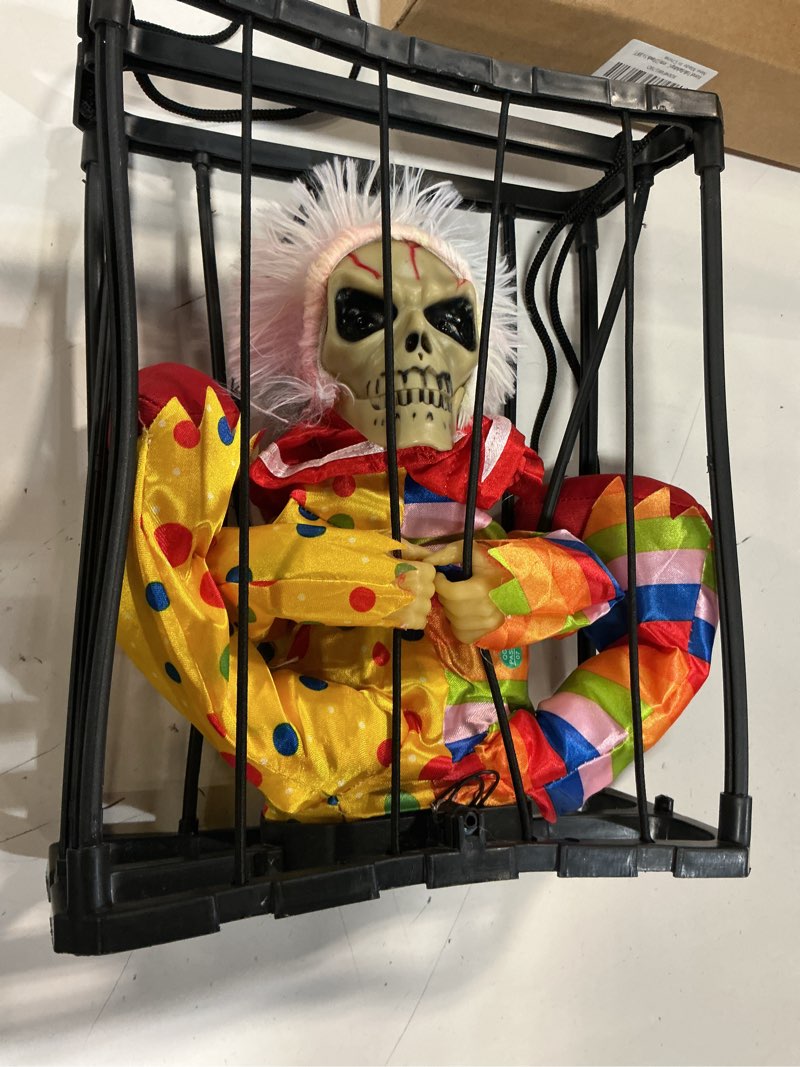 Condition photo showing Good Condition for lighted evil clown in cage halloween hanging decoration, animated skull decorations with motion sensor, creepy haunted horror prop, screaming ghost decorations for halloween yards indoor outdoor