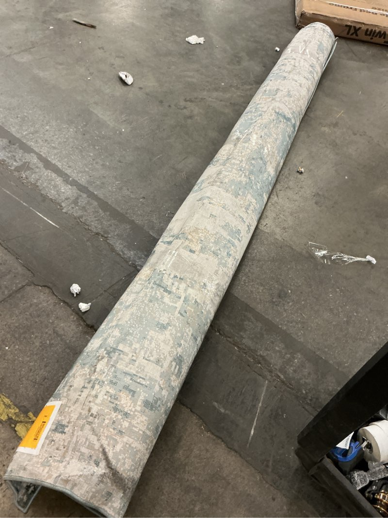 Condition photo showing As Is for 10x12 area rug blue design