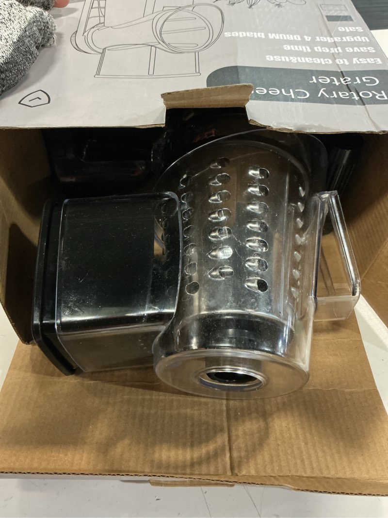 Condition photo showing As Is for rotary cheese grater with 4 blades, hand crank cheese grater with waffle slicer, red, black and white cheese shredder with suction base, easier for shredding & grating (black)