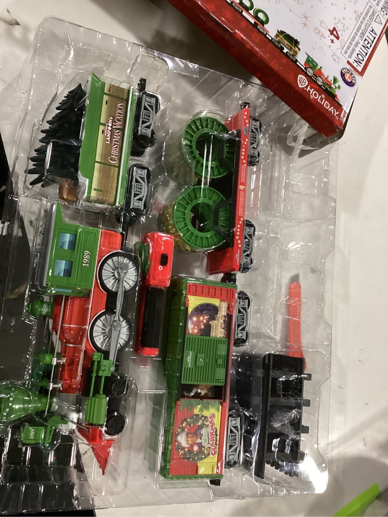 Condition photo showing As Is for Lionel Battery-Operated Christmas Vacation Toy Train Set with Locomotive, Train Cars, Track & Remote with Authentic Train Sounds, & Lights for Kids 4+